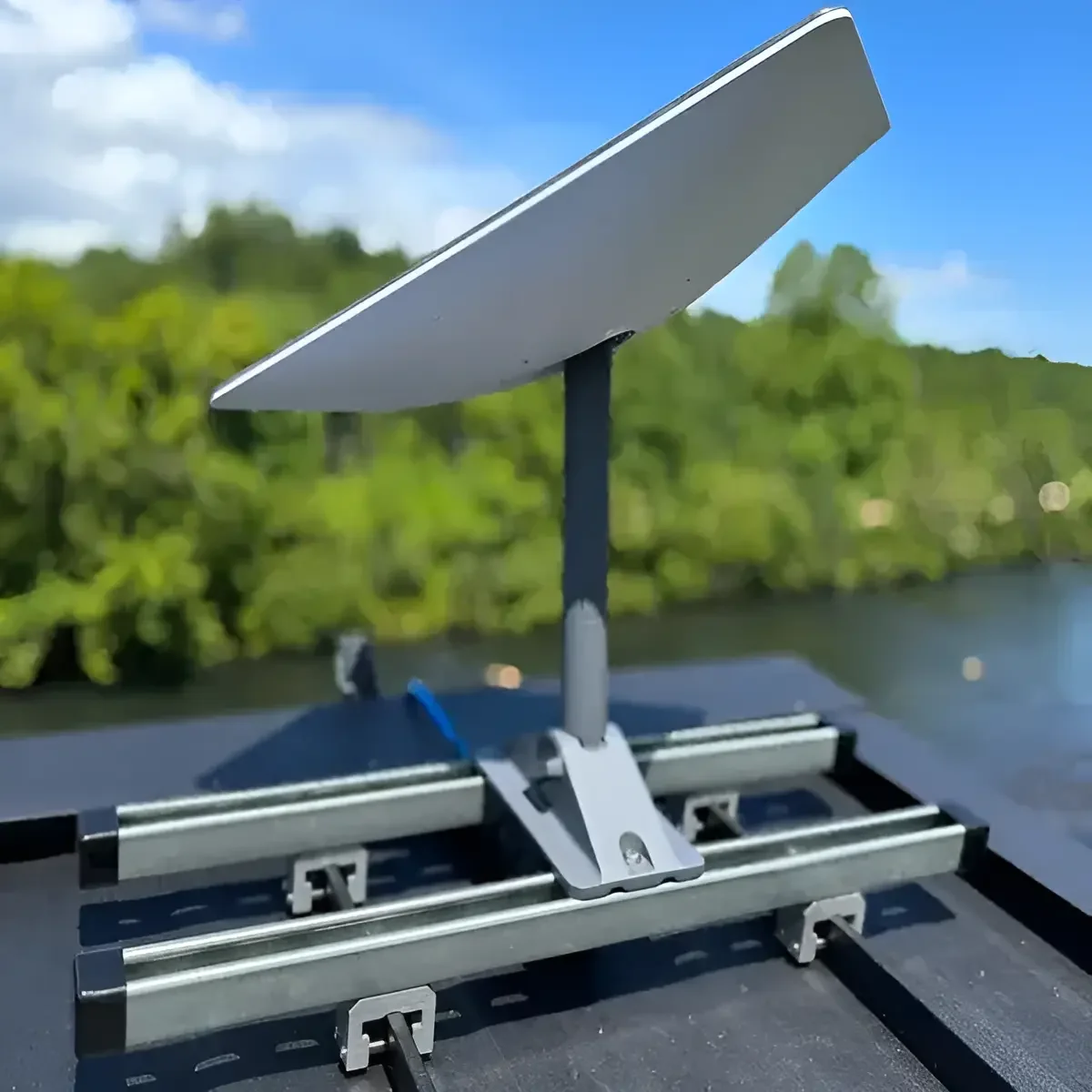 Customer-installed Starlink satellite dish with Pivot Mount secured to SataMount RCT rails on standing seam roof